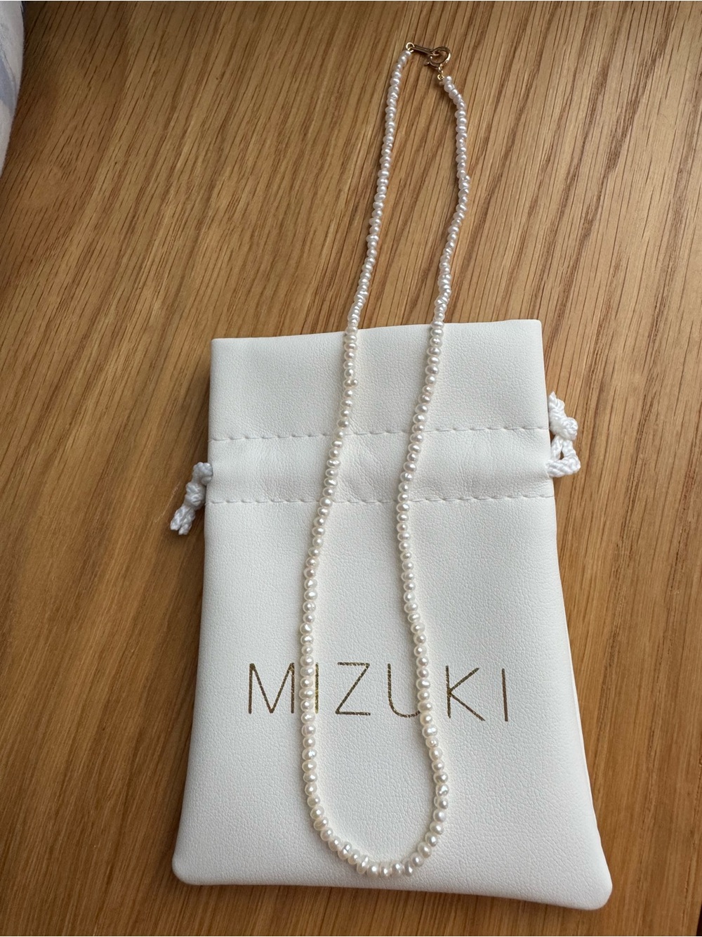 Mizuki Cream Pearl Necklace on White Drawstring Pouch